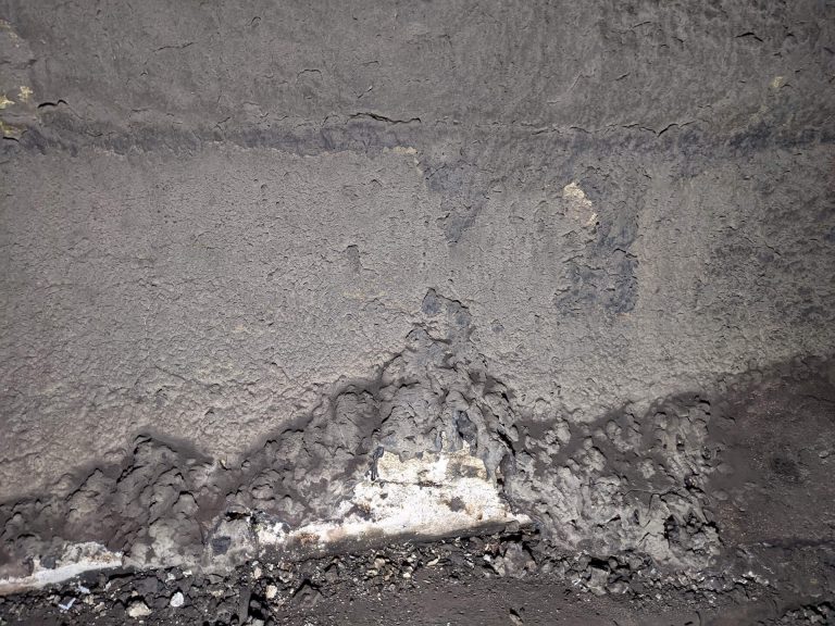 A close-up photo of damaged, melted refractories.