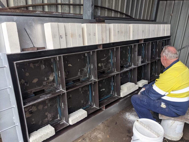 A photo showing a worker examining the steelwork for a glow panel.