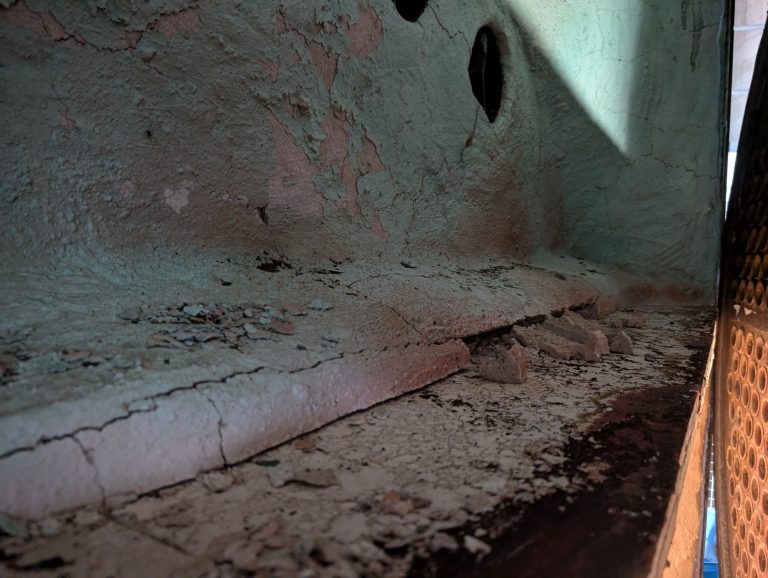 An image showing some heavily cracked refractories resting on the floor, exposing the steel beneath.