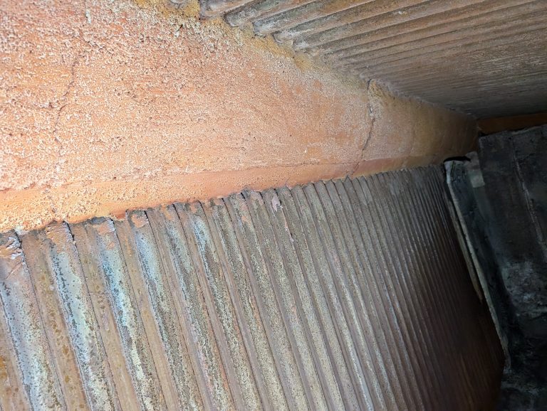 A photo showing cast refractory in the top corner of a boiler, with minor cracking.